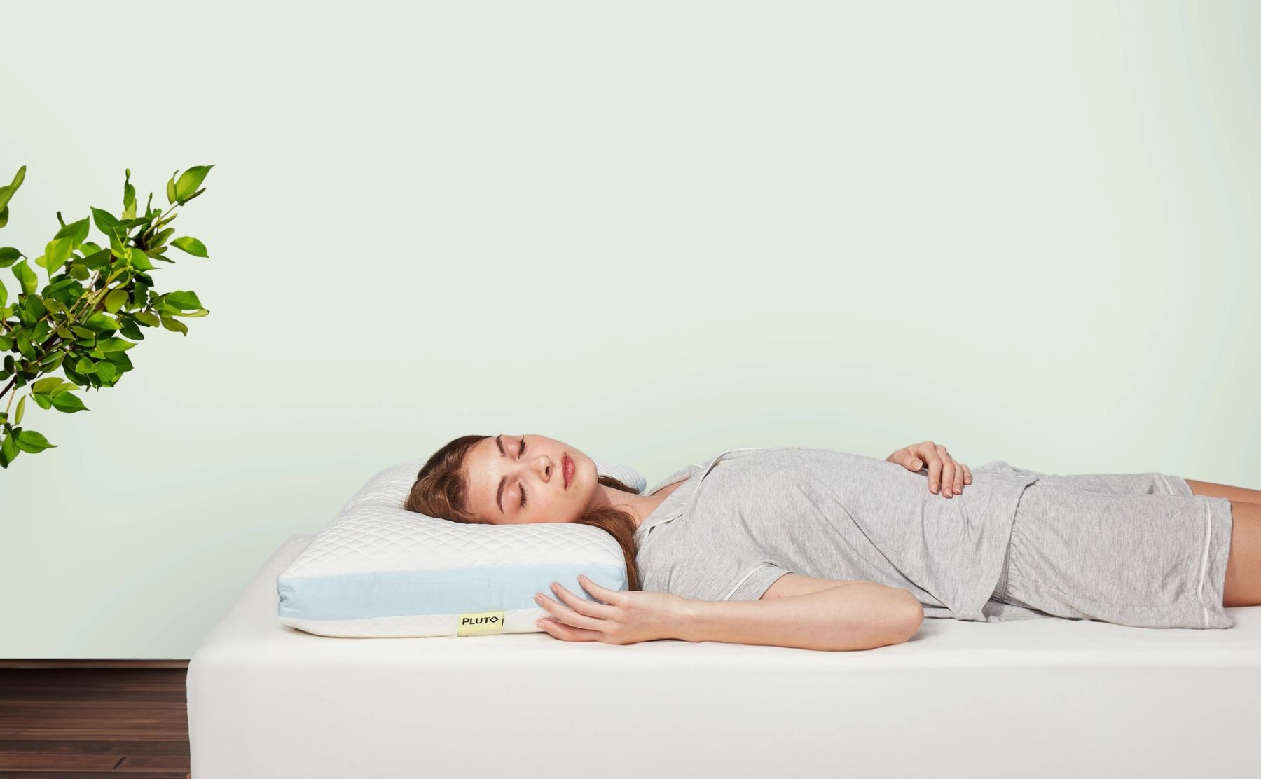 Girl laying on a Pluto Pillow